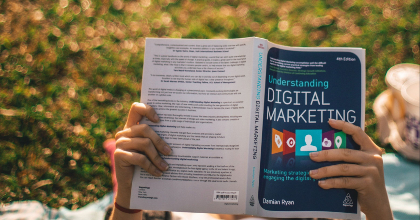 laying in the park reading a book